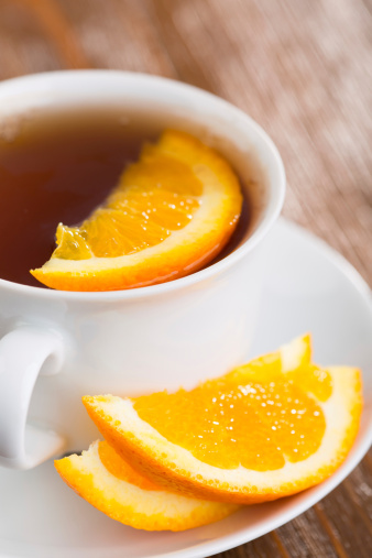 Cup of green tea with orange fruit