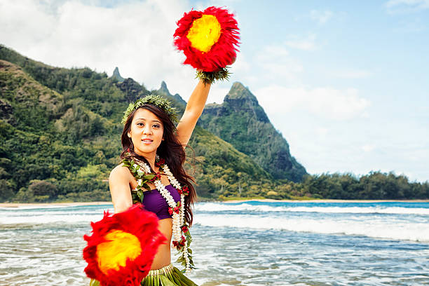 hawaiian bailarina de hula en la playa con pluma roja shakers - makana peak fotografías e imágenes de stock