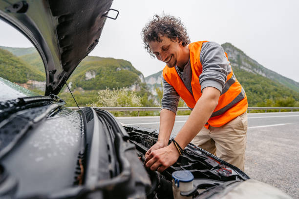 istock Cheerful Young Man Having Car Problems On The Road In The Rain 1603076198