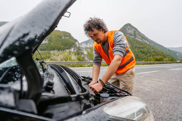 istock Young Man Having Car Problems On The Road In The Rain 1603080415