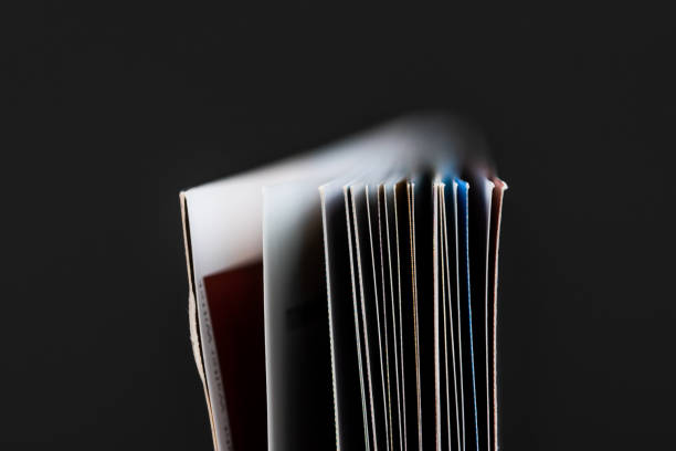 istock Closeup of open book pages on dark background. 1603093559