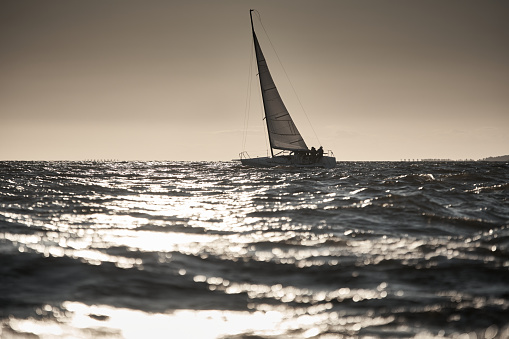 Yacht Sailing along the horizon on calm waters