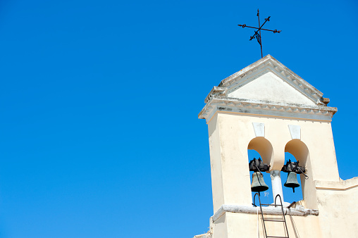 Six bells in a tower at a church at Oia on Santorini island in Greece