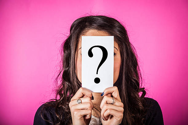 istock Woman holding card with question mark in front of face 160311357