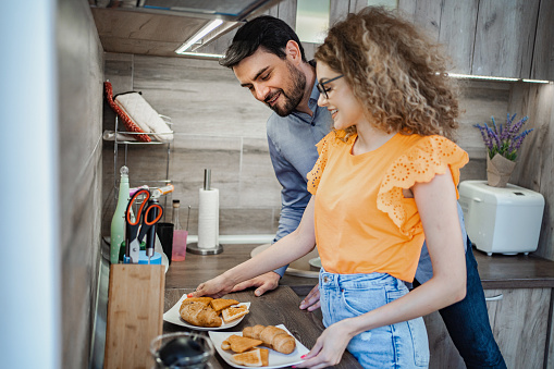 Young couple preparing breakfast together in the kitchen