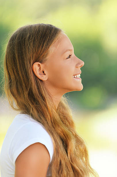 istock young beautiful smiling girl in profile 160311955