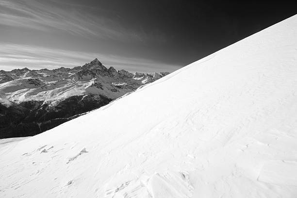 istock Snowy slope in scenic high mountain background 160312332