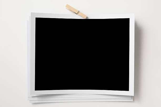 istock Stacked blank photo frames with paper clip on white background 160312418