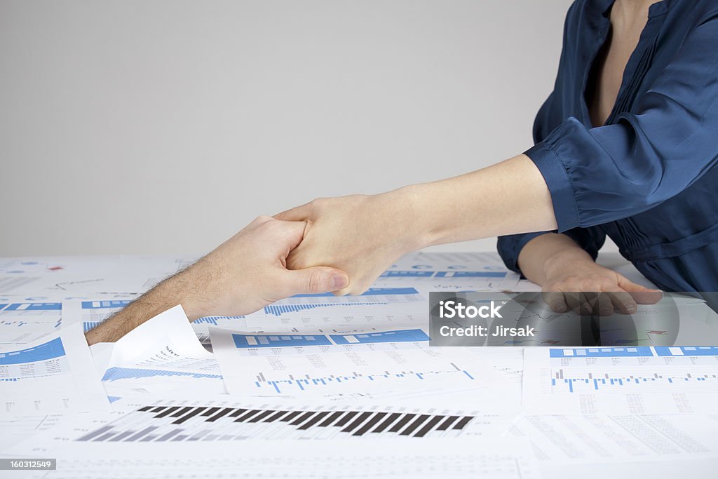 Helping hand against bureaucracy Helping hand against bureaucracy (rescue of paperwork) for manager by administrative worker. Drowning Stock Photo