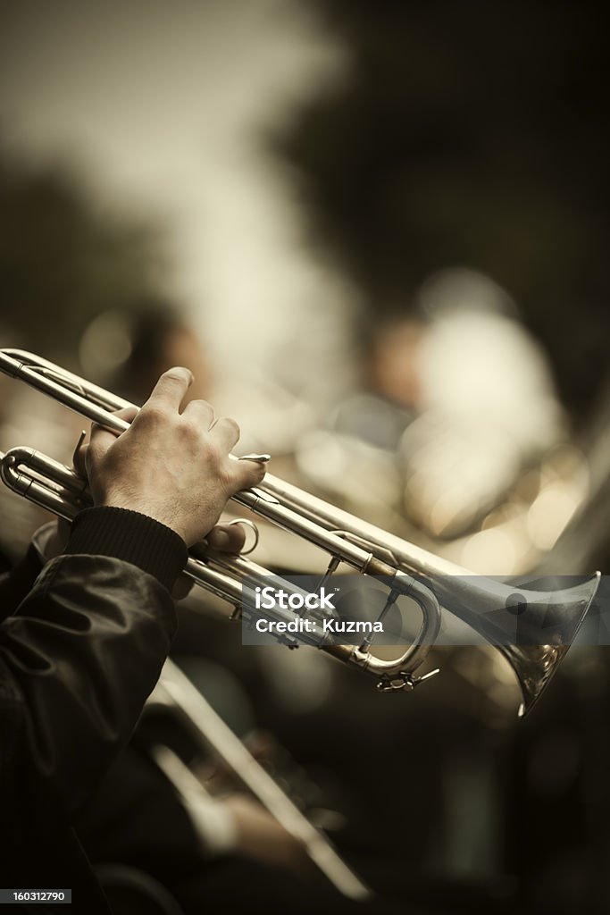 Jazz on the street jazz band playing on the street, selective focus on the hands with trumpet ,film f/x Trumpet Stock Photo