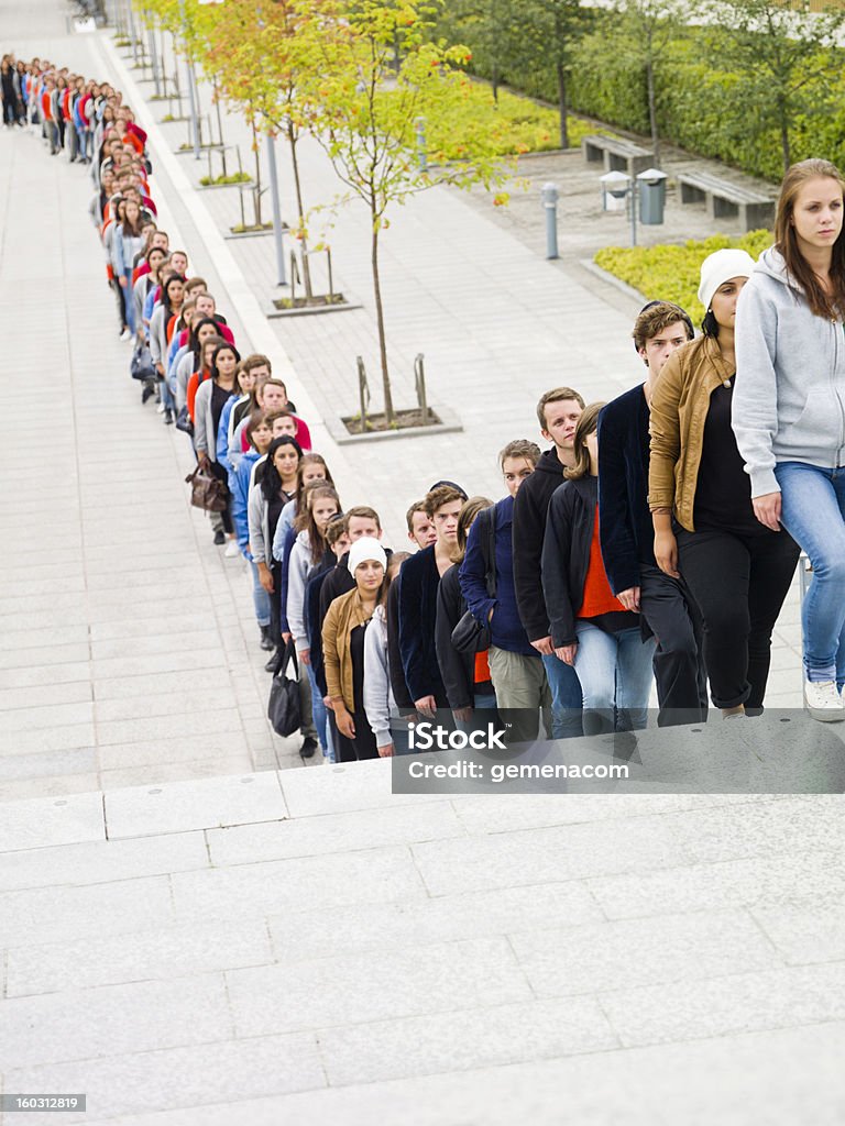 People waiting in long line Large group of people waiting in line Waiting In Line Stock Photo