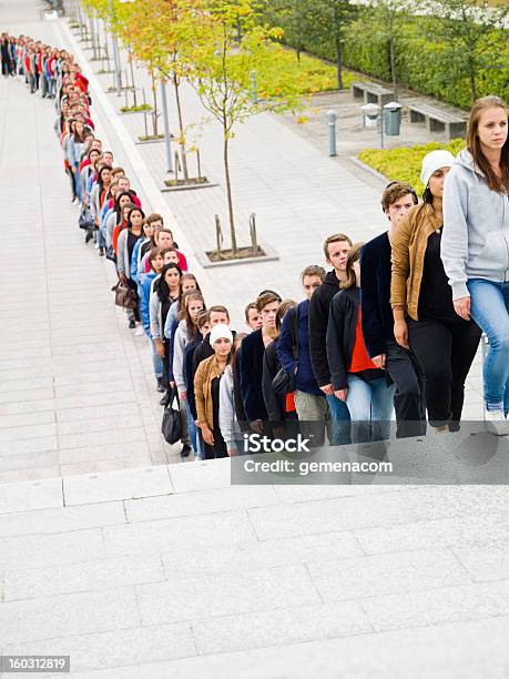 People Waiting In Long Line Stock Photo - Download Image Now - Waiting In Line, Long, People In A Row