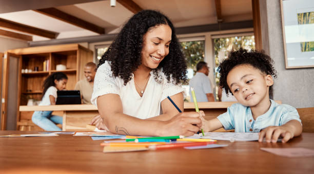 istock Learning, education or mom with kid drawing in book in house for studying, homework or artistic hobby. Happy family development, growth and creative baby boy or toddler with mother teaching him art 1603141017