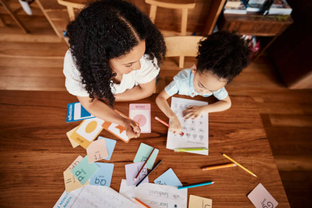 Learning, home and family with child from above for language helping, education and writing development. Mother or woman with kid creativity support and teaching him abc, creative and drawing skills