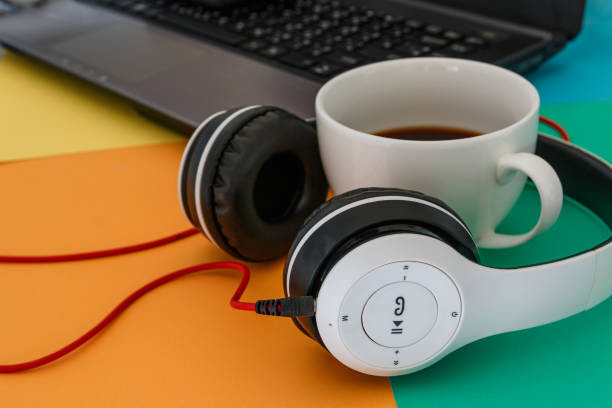 istock Headphones and Coffee cup on a difference colorful bright board background. 1603144287