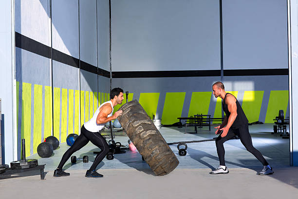 gym flip tires men flipping each other