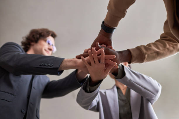 istock Diverse business team joining hands in unity celebrating success 1603174637