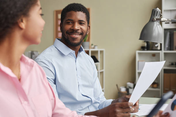 istock Smiling man and woman collaborating on project 1603178770