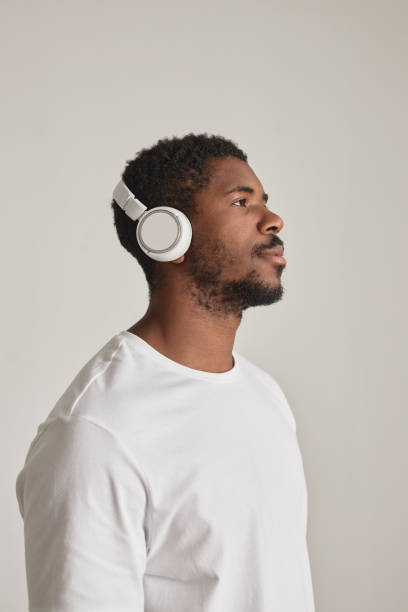 istock Black man wearing headphones against white 1603179045