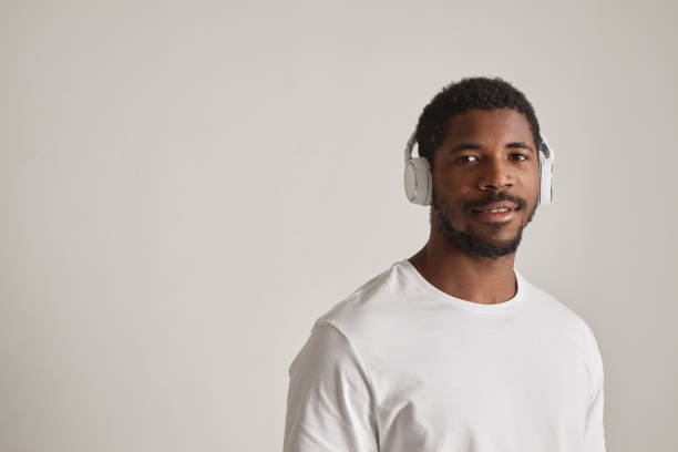 istock African American man wearing headphones on white 1603179059