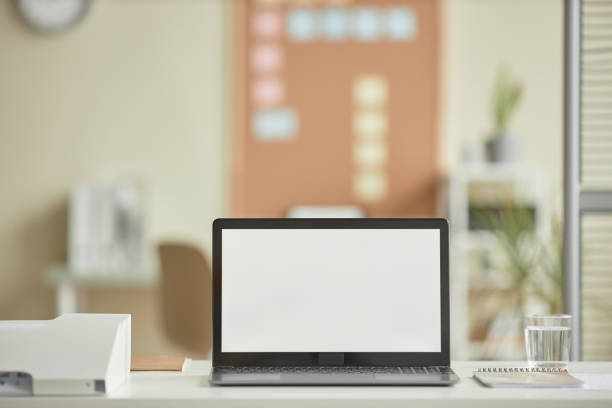 istock Minimal open laptop  with blank white screen mockup on desk in office workplace 1603179589