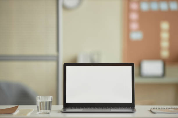 istock Open laptop  with blank white screen mock up on desk in office 1603179591