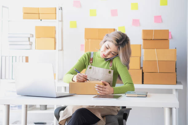 istock Businessman hands working on a smartphone with packaging box, Business online influencer on social media concept, Online Selling, Online Shopping to market, business E-commerce. 1603180681
