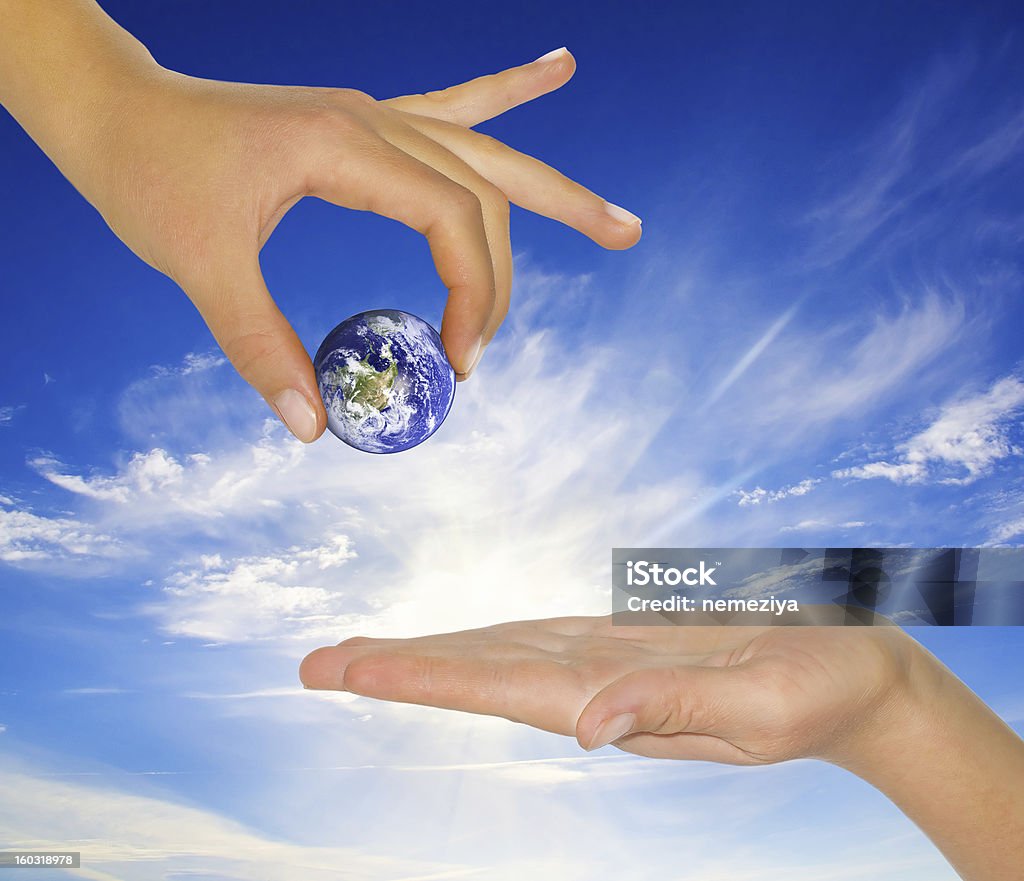 female hand holding earth. Female hand holding earth. Conceptual symbol of the Earth with human hands. Adult Stock Photo