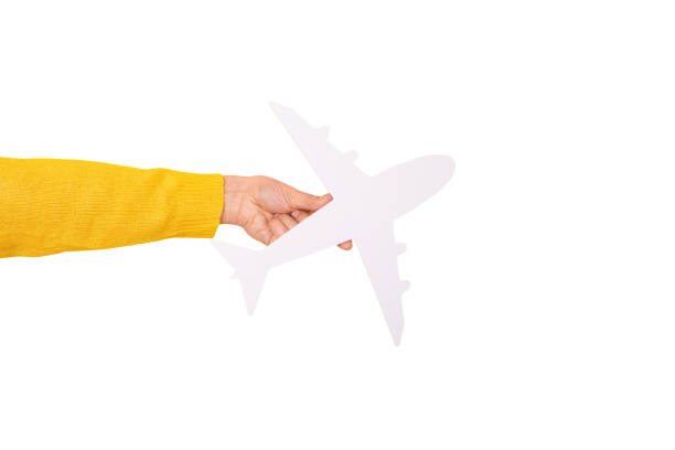 istock hand holding white airplane isolated on white background 1603198599