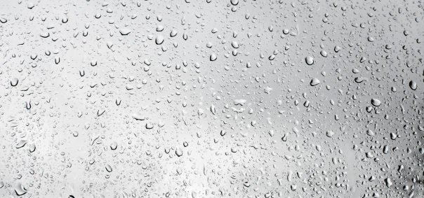 Raindrops on an apartment window on a stormy cold winter morning. Low depth of field.