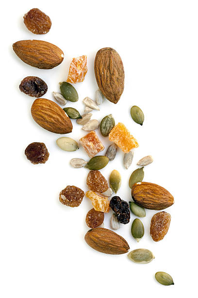 Trail Mix Isolated Trail mix isolated on white background.  Overhead view. dried fruit on white stock pictures, royalty-free photos & images