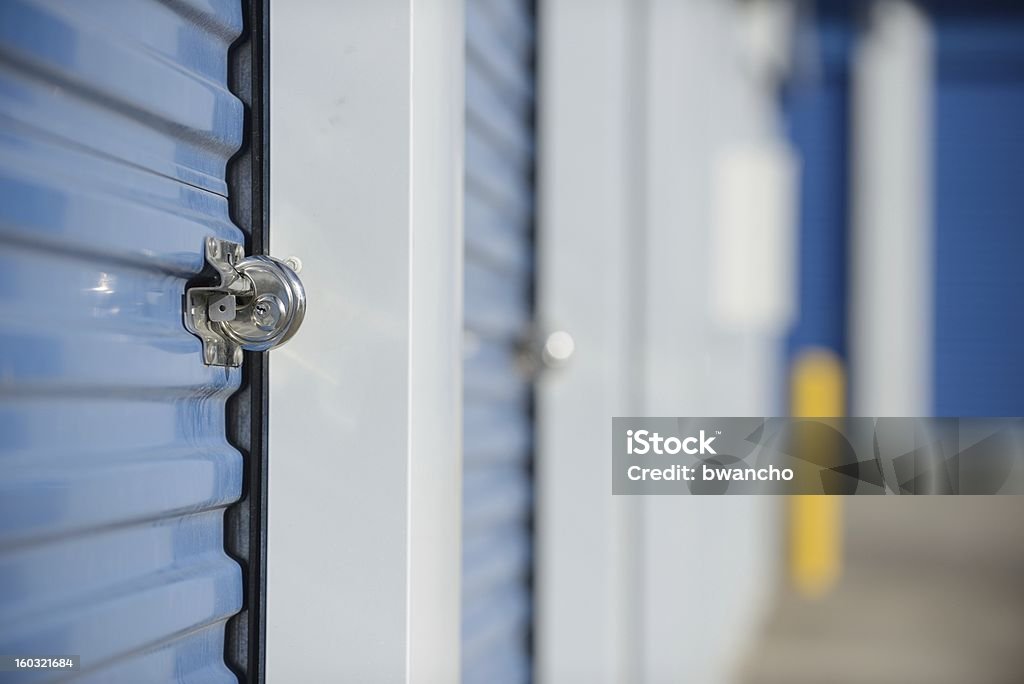Locked self storage unit. Lock on a self storage unit door. Shallow DOF. Storage Compartment Stock Photo
