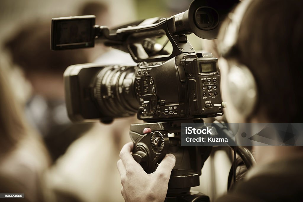news shooting professional camcorder on the tripod, selective focus on nearest part Home Video Camera Stock Photo