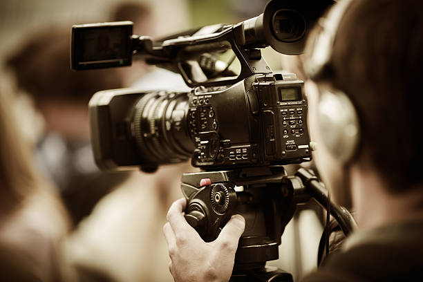 news shooting professional camcorder on the tripod, selective focus on nearest part television camera photos stock pictures, royalty-free photos & images
