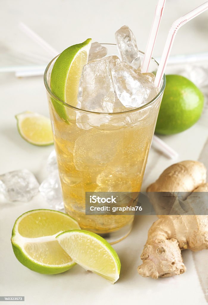 Yellow drink with lime, ginger and ice Alcohol - Drink Stock Photo