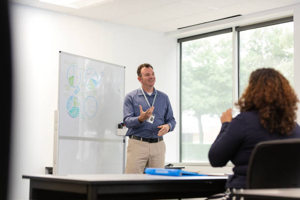 istock Male CEO presents graphs during business strategy meeting with co-workers 1603237313