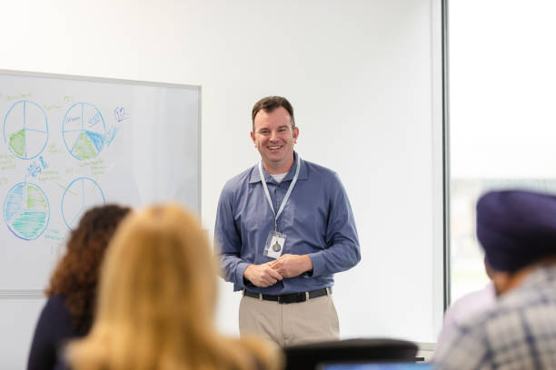 istock Male consultant takes questions from unrecognizable seminar attendees 1603237321