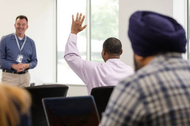 istock Focus on businessman raising hand during seminar 1603237350