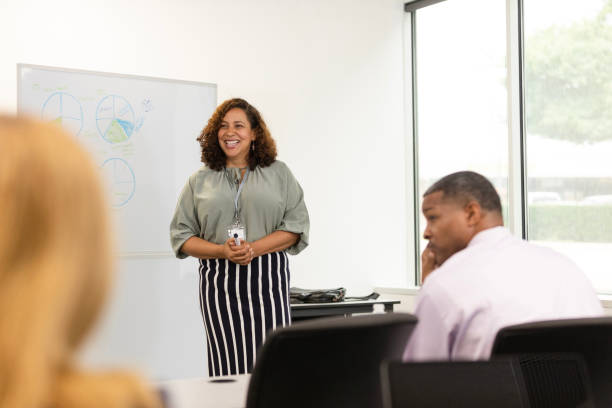 istock Smiling female CEO interacts with employees during meeting 1603237353