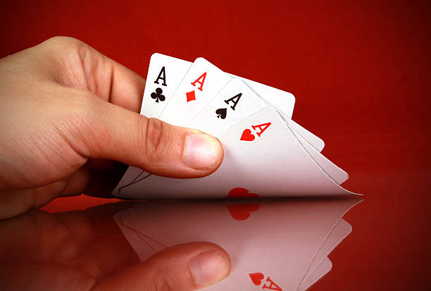istock playing cards (four of a kind) in the hand 160323819