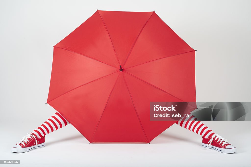 The girl hiding behind a large red umbrella Adult Stock Photo