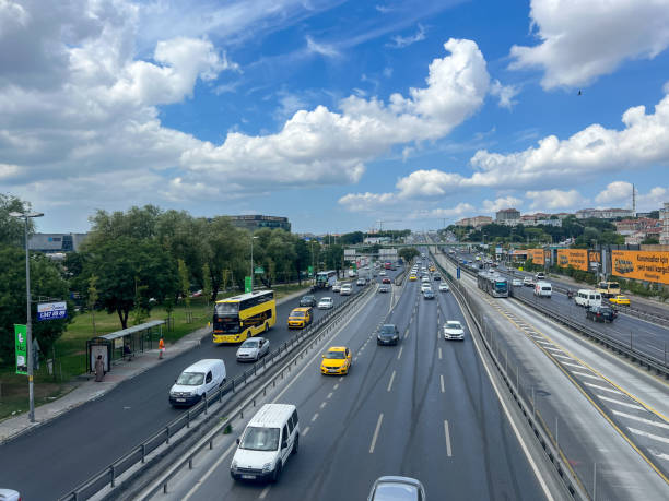 cars and vehicles driving on road under beautiful blue sky in a sunny day in Istanbul, Turkey. stock photo