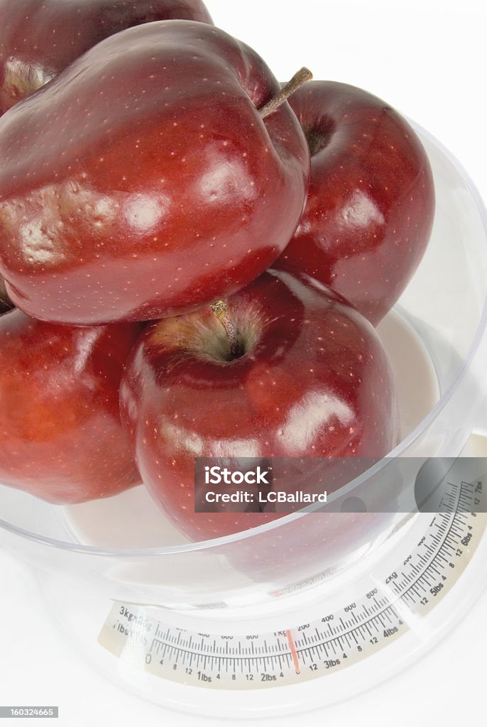 Manzana red delicious en una escala de medición aislado blanco cocina - Foto de stock de Alimento libre de derechos