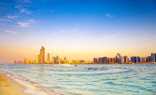 istock Beach with backdrop of Abu Dhabi skyline at sunset 160326593