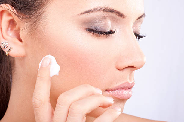 istock Girl apply cream on cheek 160327522