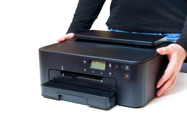 istock Side View of Inkjet Printer in Hands on White Background 1603286484