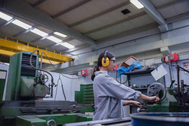 istock Young lathe worker woman working with milling machine in factory 1603289732