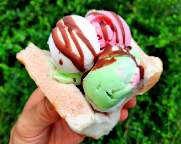 istock Ice cream on bread bun in hand. 1603296070