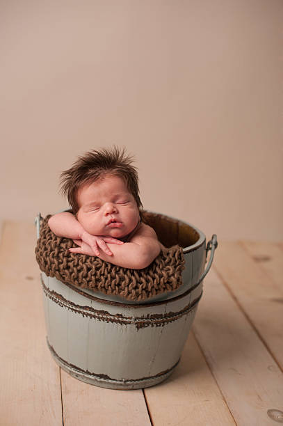 istock Sleeping Newborn in a Bucket 160330499