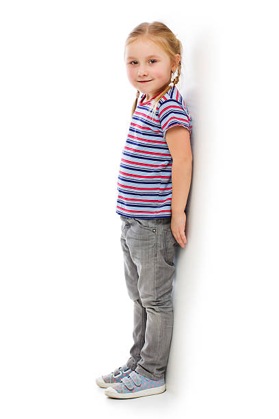 istock Little girl leaning against a white wall. 160330800